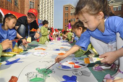 学生党员与小朋友们一起进行我心中的蓝色海洋涂鸦